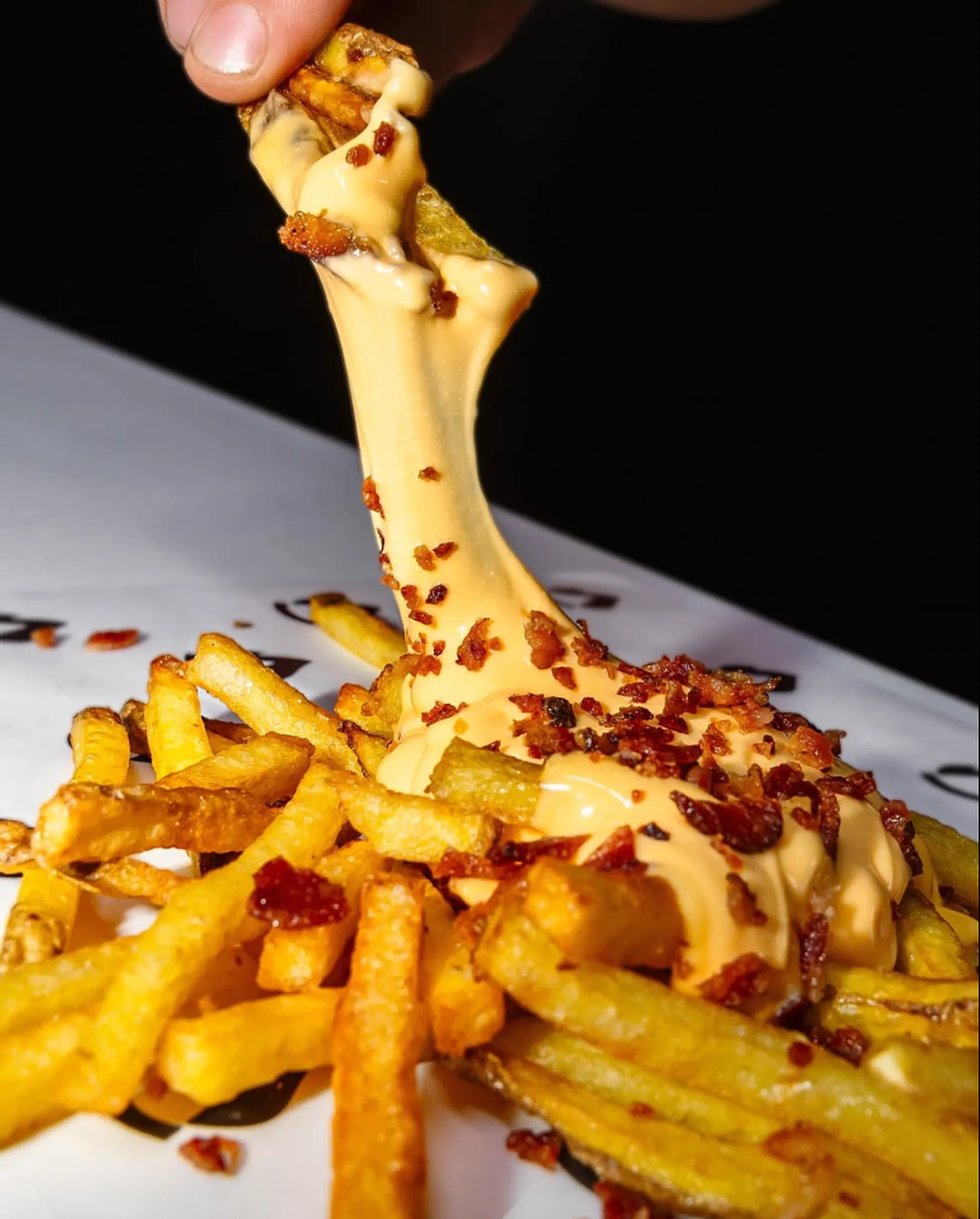 Patatas con queso fundido y bacon